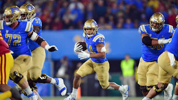 Nov 19, 2022; Pasadena, California, USA; UCLA Bruins running back Zach Charbonnet (24) runs the ball against the Southern California Trojans during the first half at the Rose Bowl. Mandatory Credit: Gary A. Vasquez-USA TODAY Sports